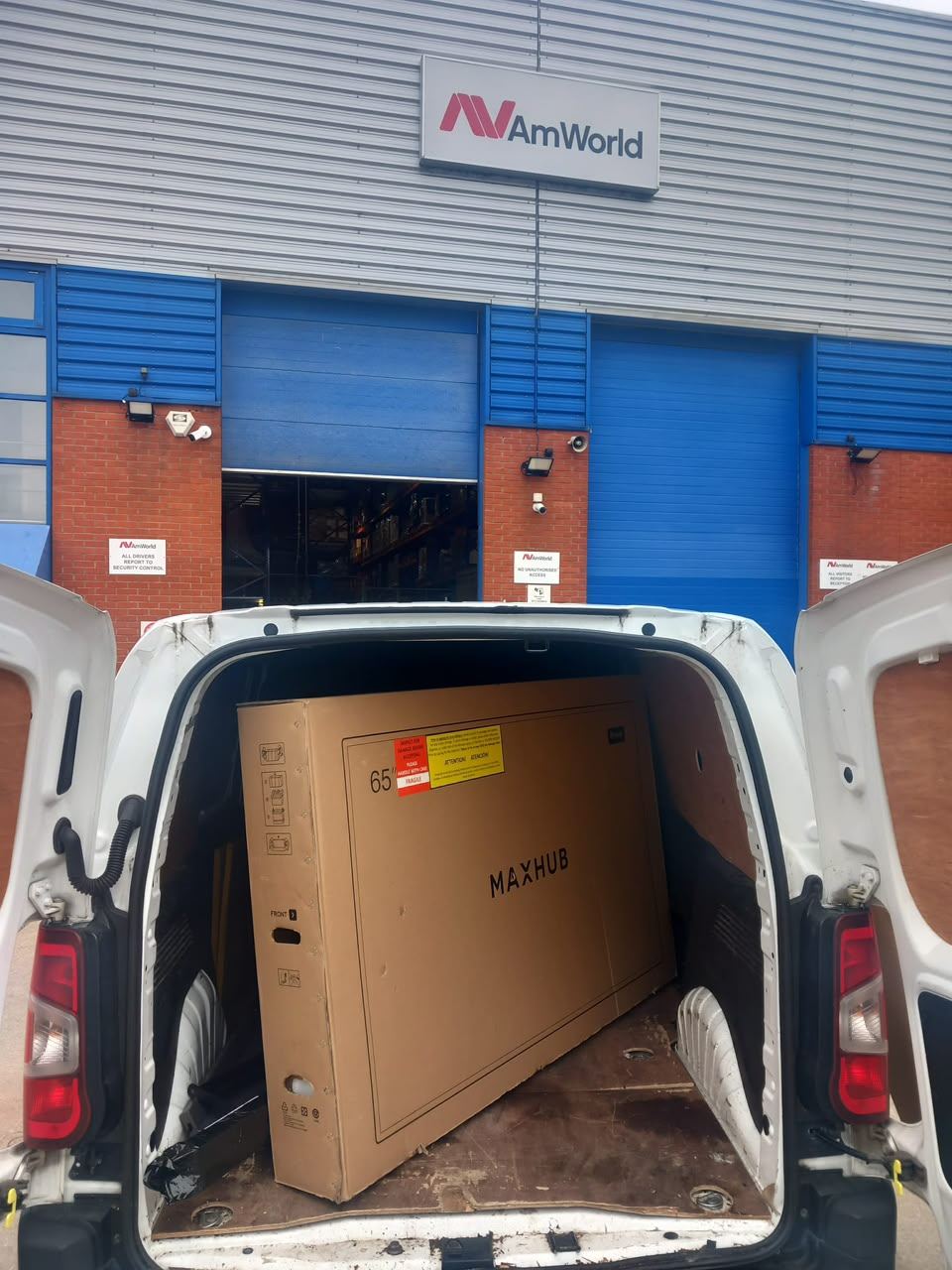 Shrink-wrapped pallet strapped upright in a van